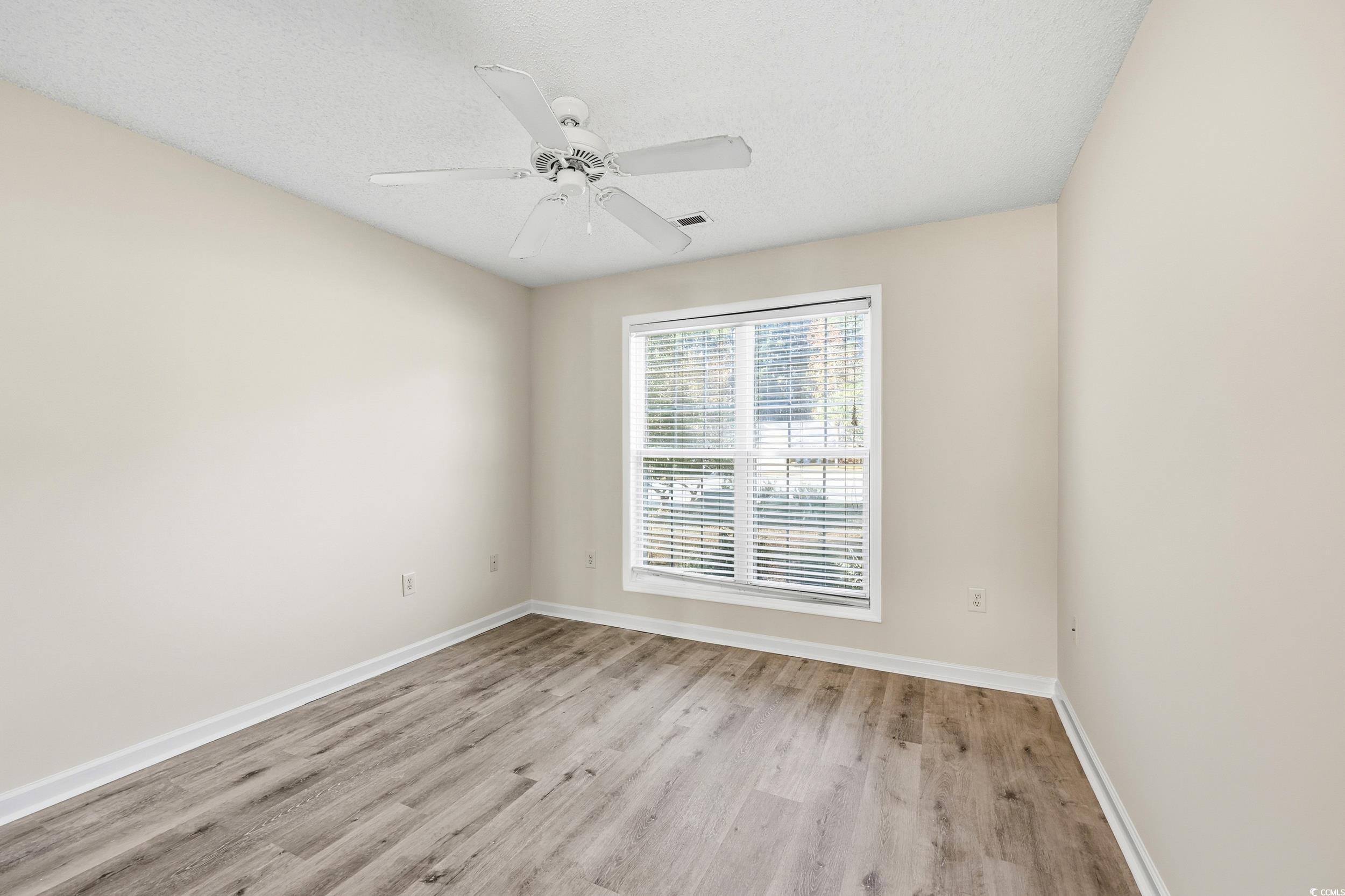 323 Chastain Court Murrells Inlet, SC 29576 - Photo 19 of 37 Unfurnished room with light wood-style floors, a textured ceiling, and a ceiling fan