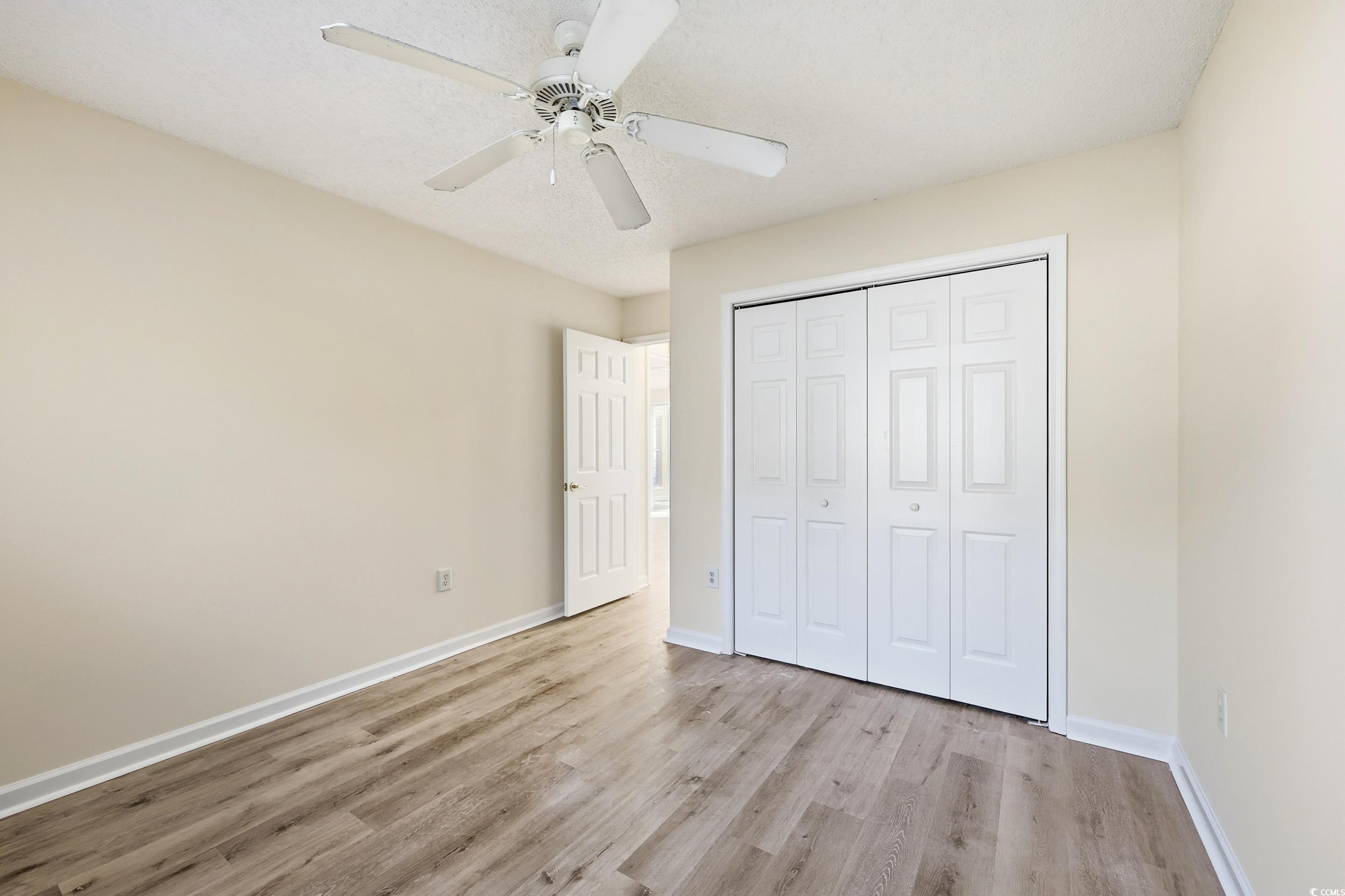 323 Chastain Court Murrells Inlet, SC 29576 - Photo 20 of 37 Unfurnished bedroom featuring light wood finished floors, a closet, and ceiling fan
