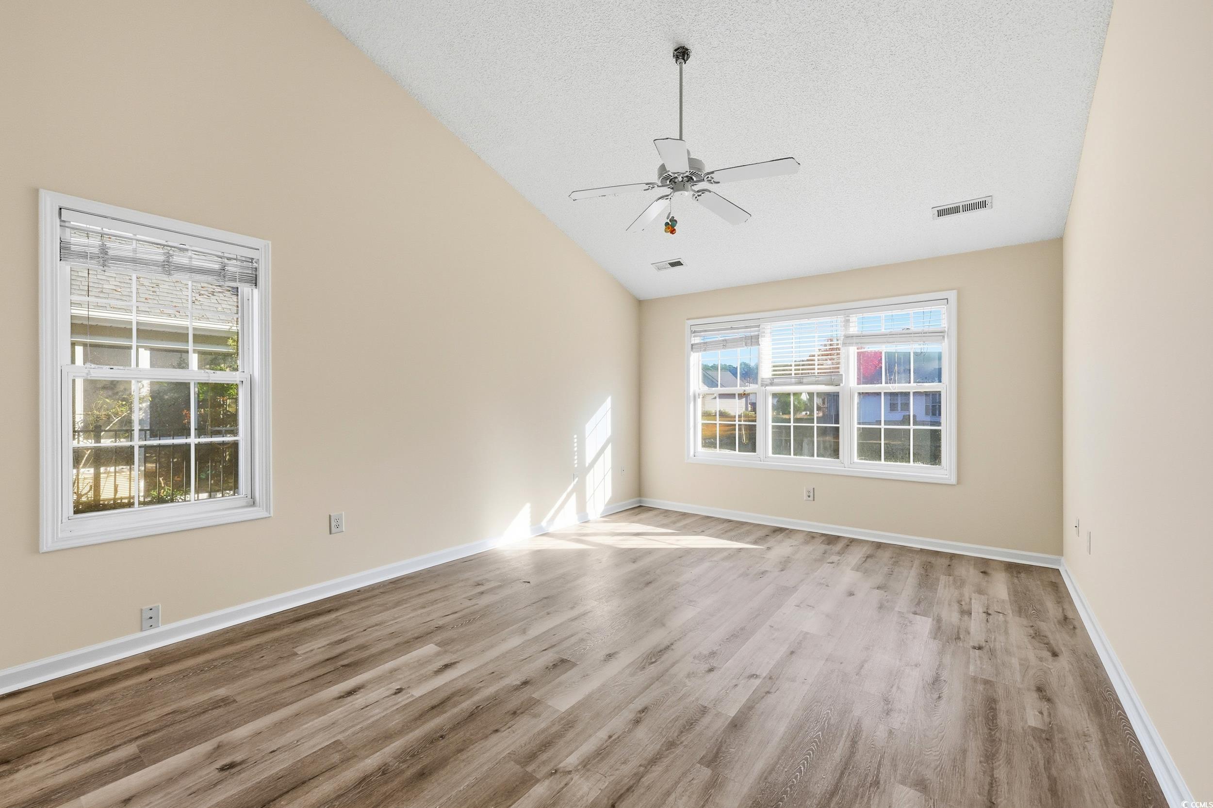 323 Chastain Court Murrells Inlet, SC 29576 - Photo 22 of 37 Spare room featuring light wood-type flooring, a textured ceiling, and a ceiling fan