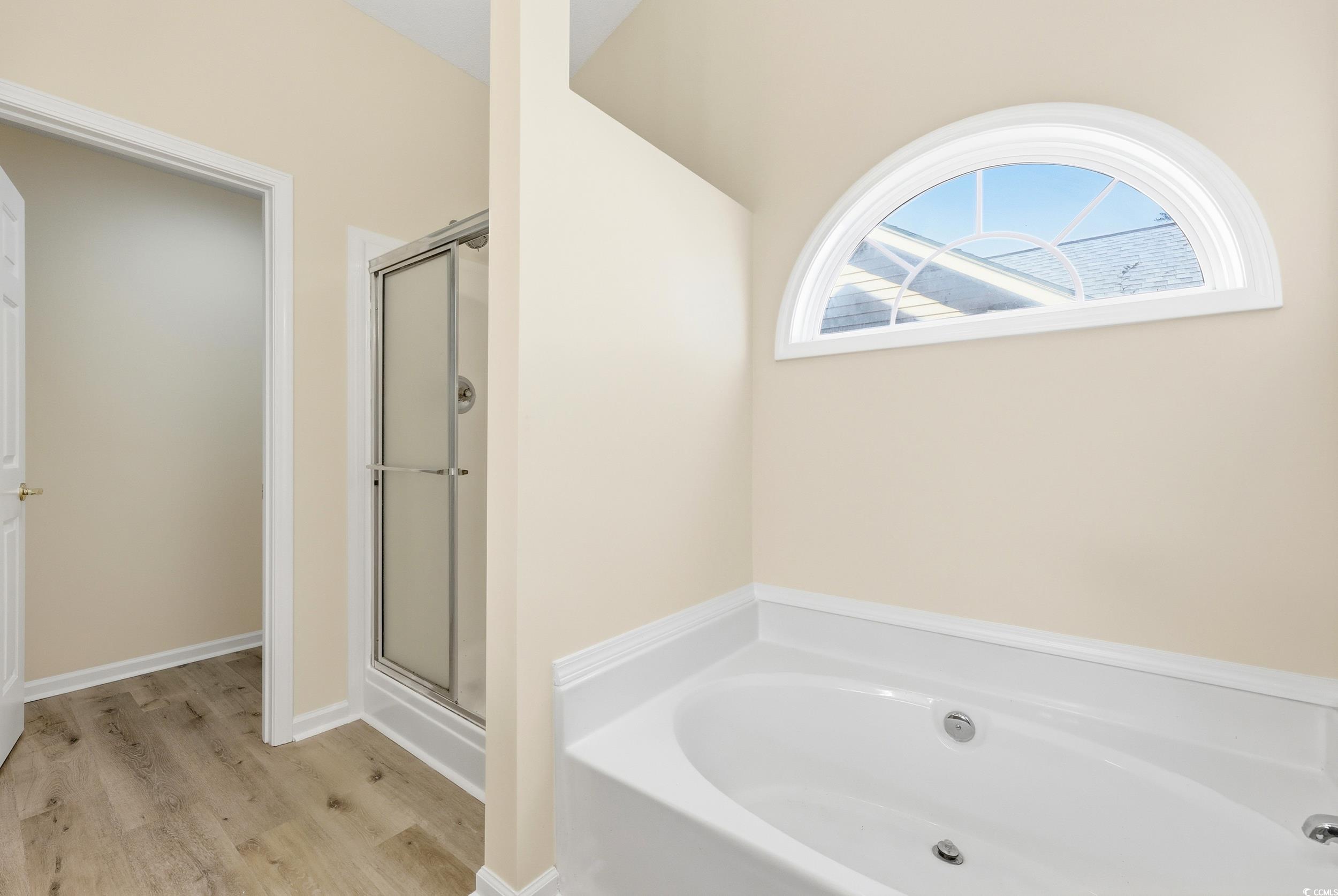 323 Chastain Court Murrells Inlet, SC 29576 - Photo 26 of 37 Unfurnished bedroom featuring light wood-style floors, high vaulted ceiling, ceiling fan, and ensuite bath