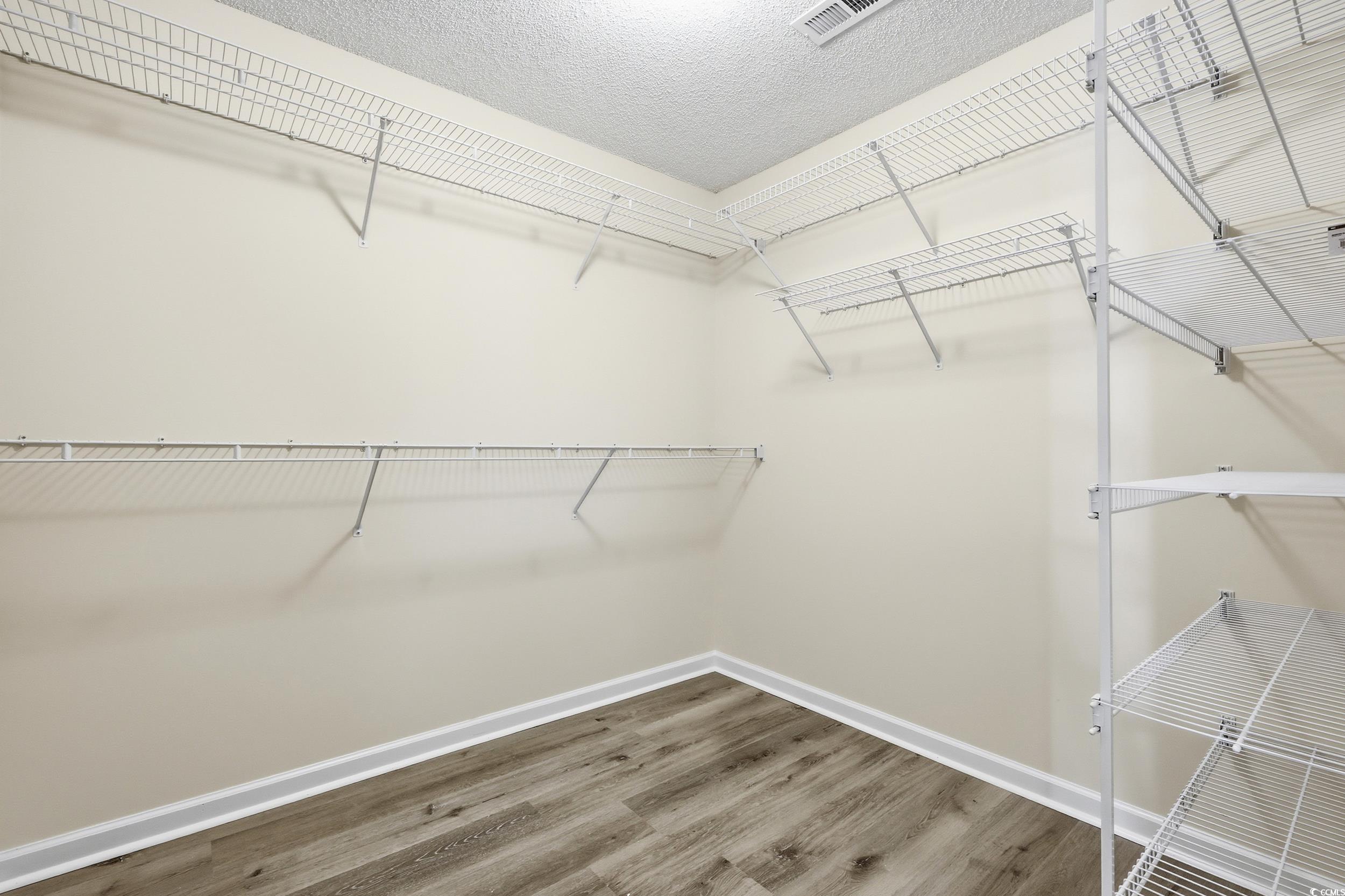 323 Chastain Court Murrells Inlet, SC 29576 - Photo 27 of 37 Bathroom with a stall shower, double vanity, and light wood-style floors