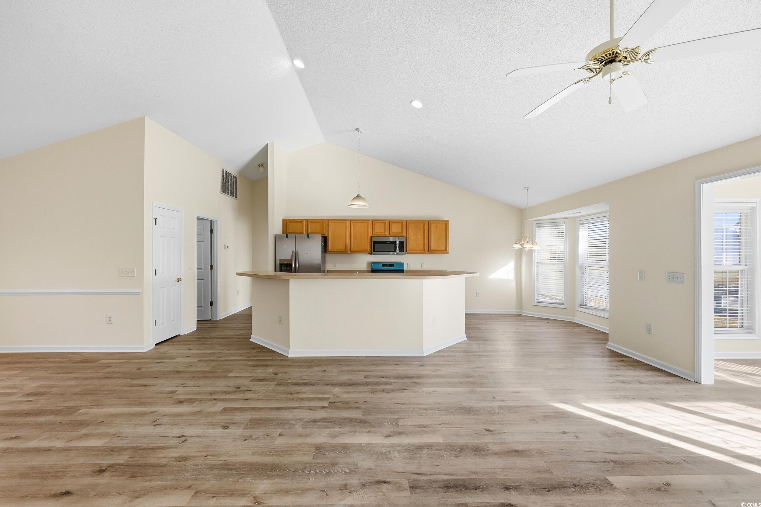 323 Chastain Court Murrells Inlet, SC 29576 - Photo 36 of 37 Kitchen with open floor plan, light wood-type flooring, appliances with stainless steel finishes, high vaulted ceiling, and recessed lighting
