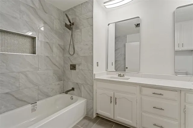 a bathroom with double sink and a mirror