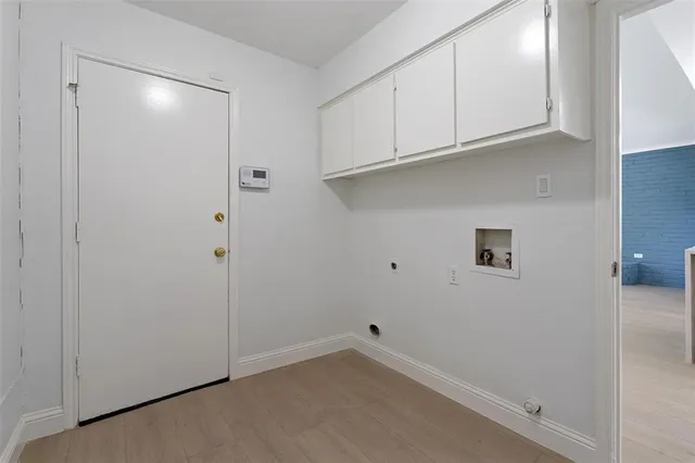 an empty room with a chandelier fan