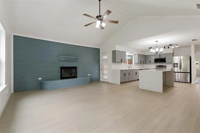 an aerial view of residential houses with outdoor space and city view