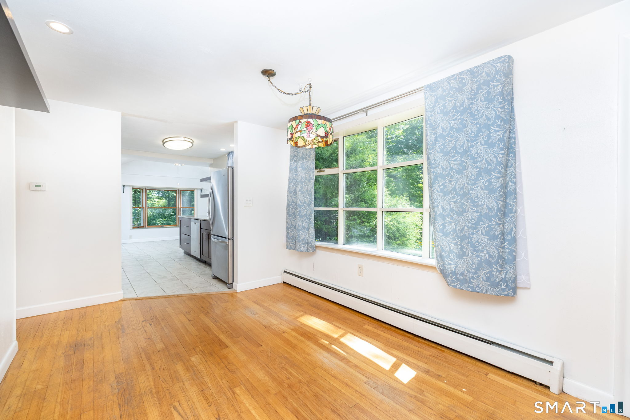 Dining area with large bay window opens to the living room & kitchen