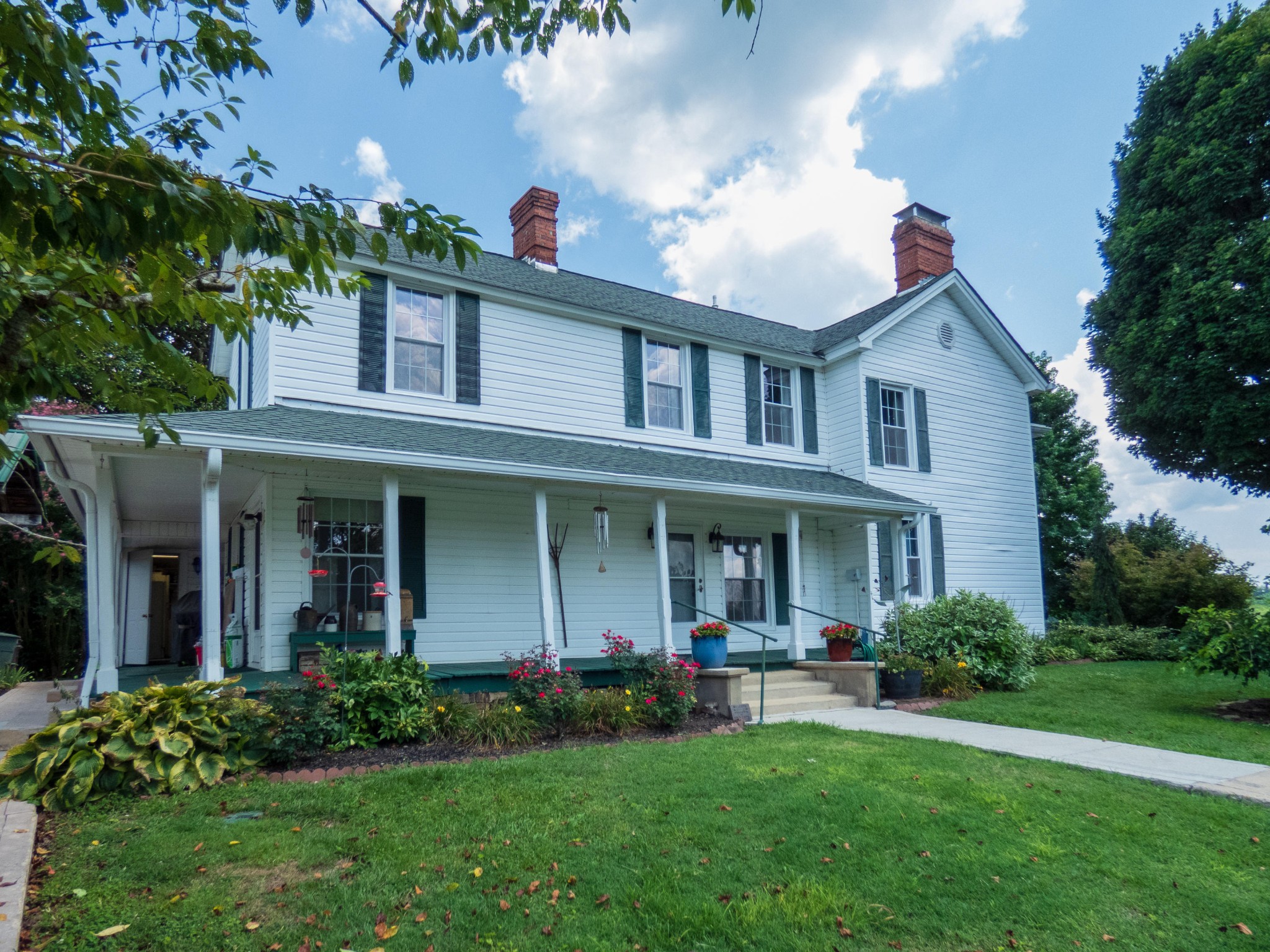 4965 Roberson Spring Road Loudon, TN 37774 - Photo 4 of 39 a front view of a house with a yard and potted plants