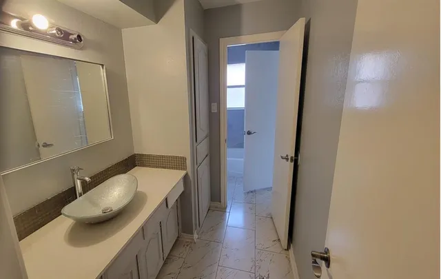 a bathroom with a sink and a mirror