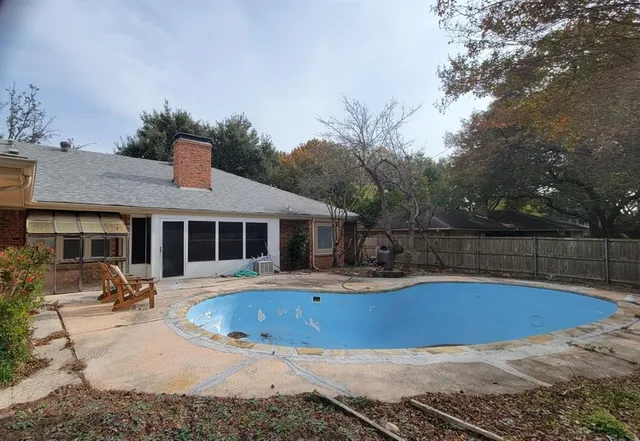 a view of a house with pool yard and sitting area