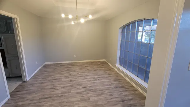 a large white kitchen with a sink stainless steel appliances and cabinets