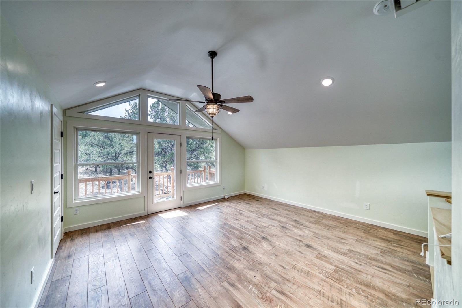 15351 Chimney Rock Road Nathrop, CO 81236 - Photo 13 of 48 a view of an empty room with wooden floor and a window