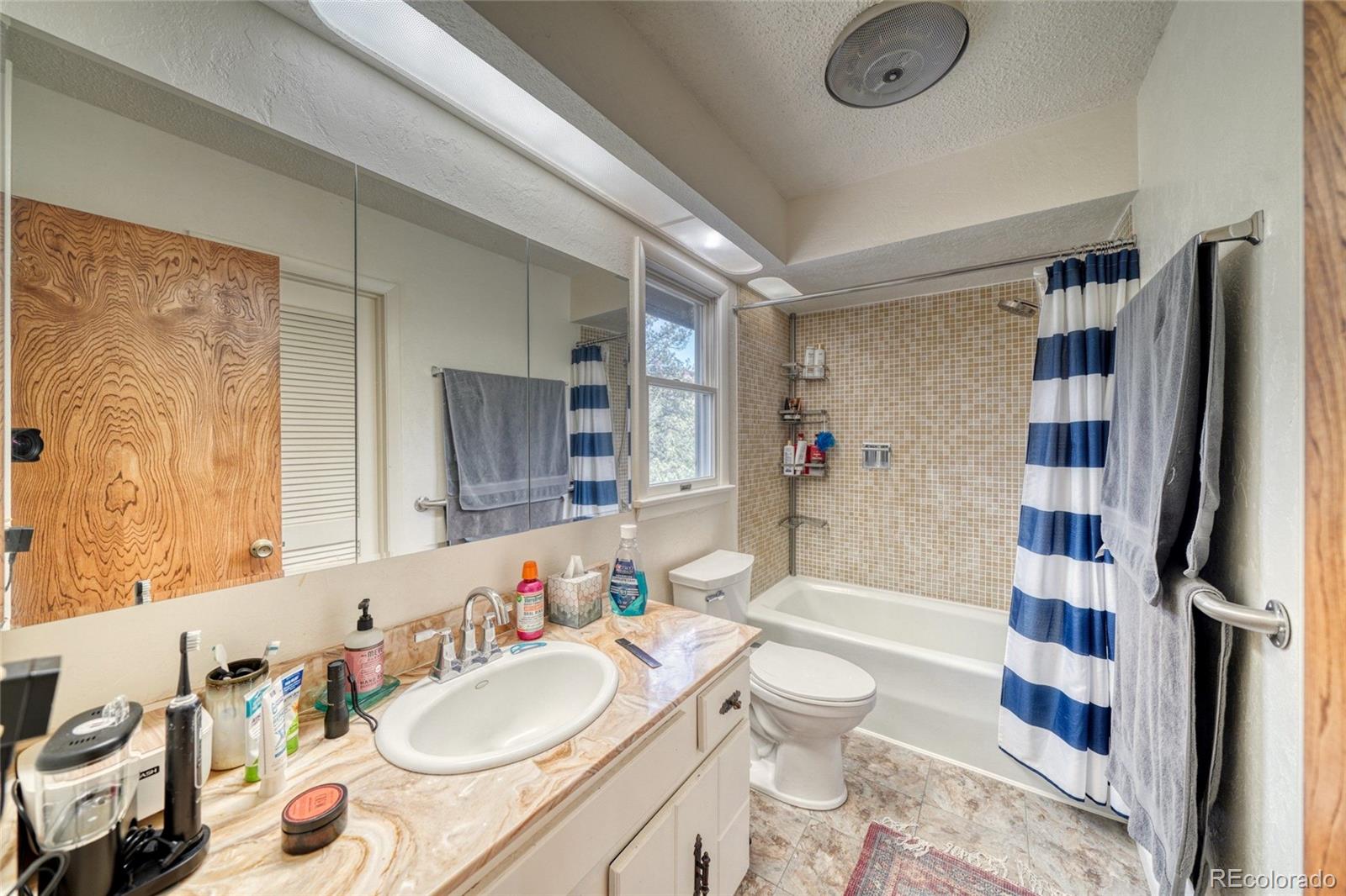 15351 Chimney Rock Road Nathrop, CO 81236 - Photo 30 of 48 a bathroom with a granite countertop sink and a mirror