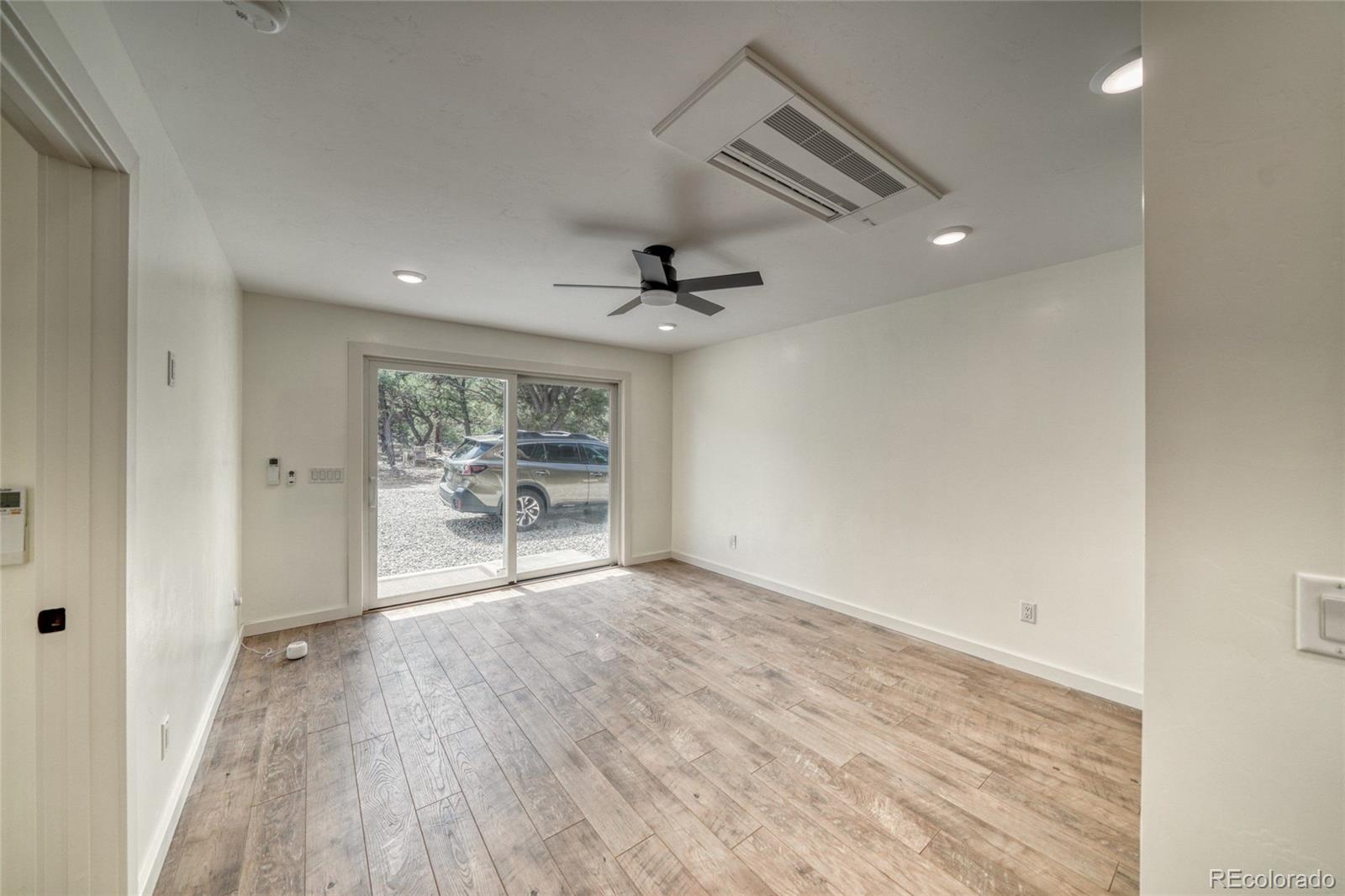 15351 Chimney Rock Road Nathrop, CO 81236 - Photo 6 of 48 wooden floor in an empty room with a window