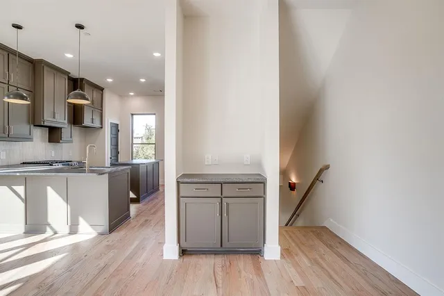 a kitchen with a sink and a chandelier