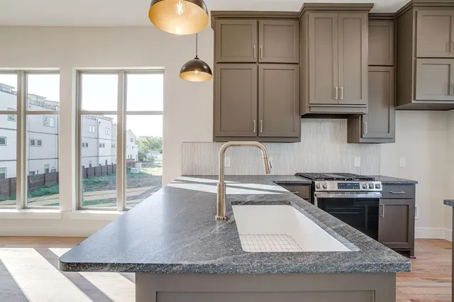 a stove top oven sitting inside of a kitchen