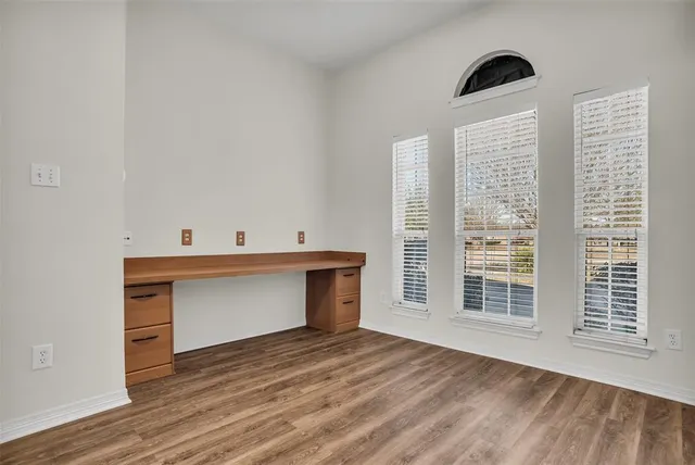 a view of room with wooden floor and window
