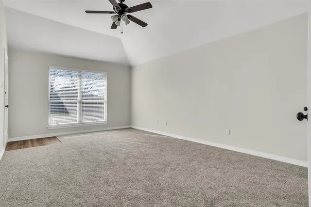 a view of a livingroom with a ceiling fan and window