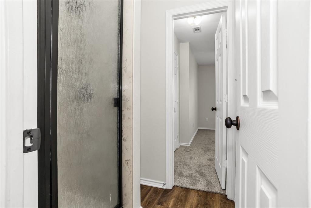 233 Cobblestone Circle Red Oak, TX 75154 - Photo 18 of 23 a view of a bathroom from a hallway