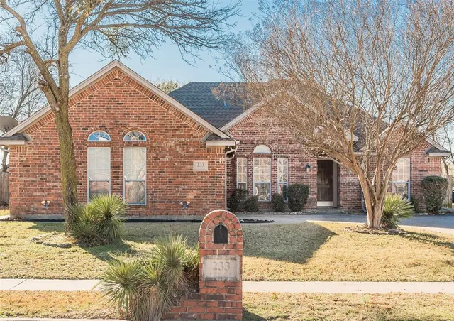 a backyard of a house with large trees and outdoor seating