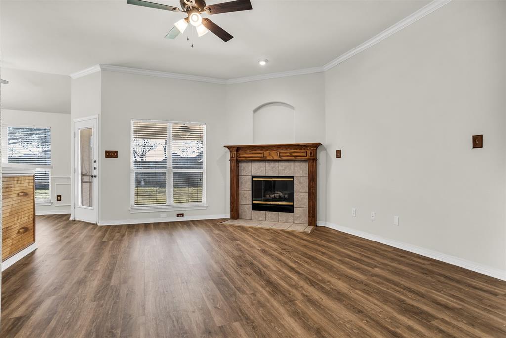 233 Cobblestone Circle Red Oak, TX 75154 - Photo 4 of 23 wooden floor fireplace and windows in an empty room