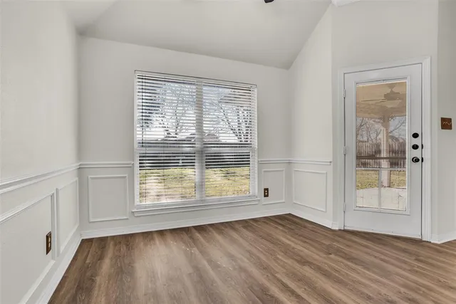 a view of wooden floor and windows in a room