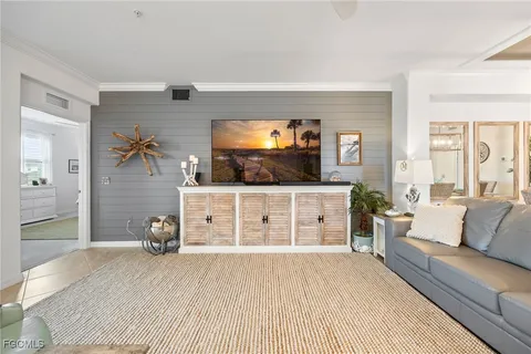 a bedroom with furniture and a flat screen tv