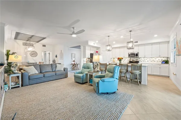 a living room with lots of furniture and kitchen view