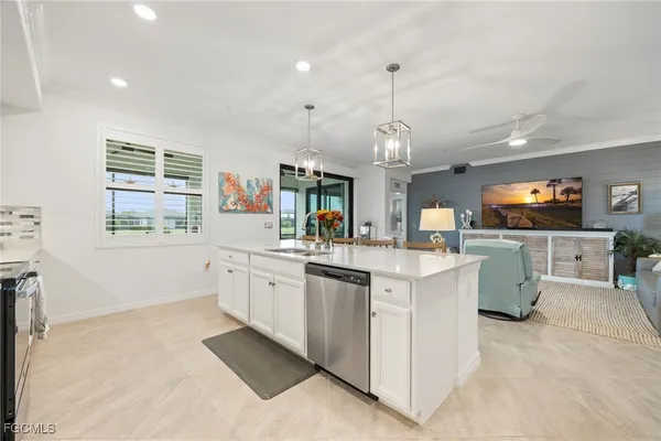 a large kitchen with kitchen island white cabinets and stainless steel appliances