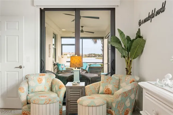 a living room with furniture plant and a large window