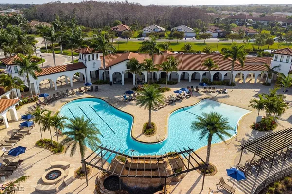 an aerial view of residential houses with outdoor space and parking