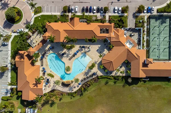 an aerial view of a house with a swimming pool outdoor seating