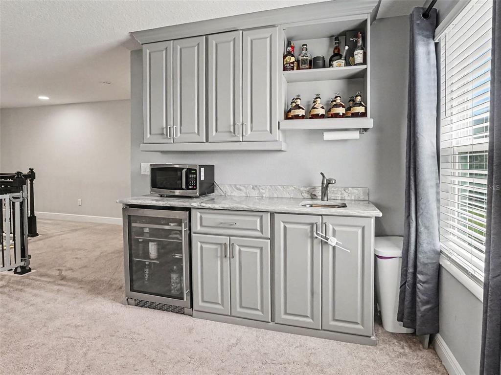 5270 Obsidian Gate Road Mount Dora, FL 32757 - Photo 26 of 50 a kitchen with white cabinets and window