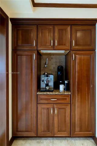 a front view of a house with swimming pool table and chairs