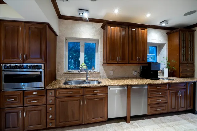 a living room with patio furniture and a floor to ceiling window