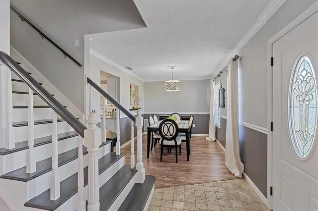 a view of a hallway with chairs and stairs