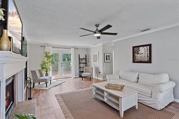 a living room with furniture a fireplace and a large window