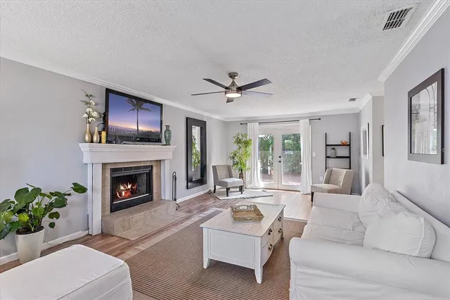 a living room with furniture a fireplace and a flat screen tv
