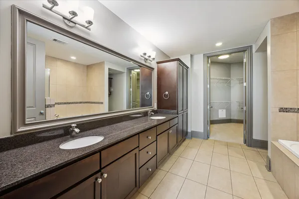a bathroom with a granite countertop sink mirror and a shower