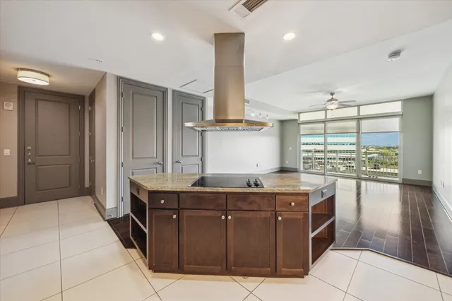 a kitchen with stainless steel appliances granite countertop a sink and a stove