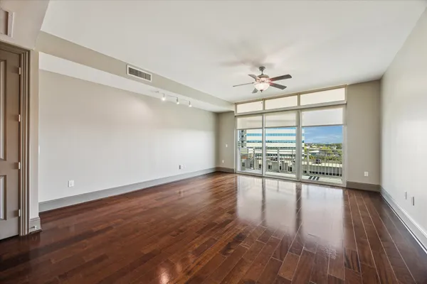 wooden floor in an empty room with a window