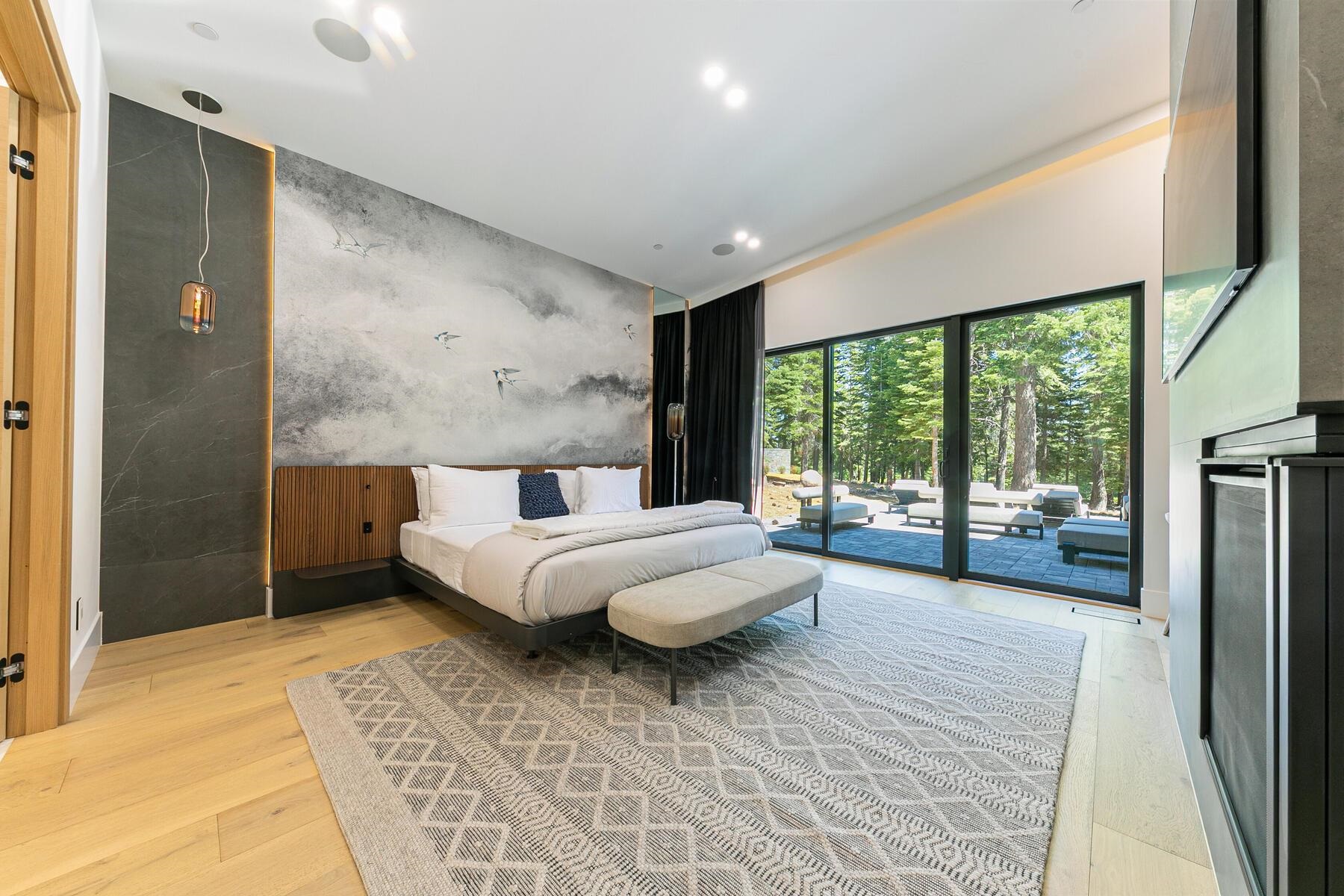 9287 Brae Road Truckee, CA 96161 - Photo 12 of 28 a spacious bedroom with a large bed and a large window