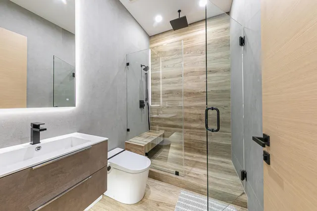 a bathroom with a toilet sink and shower