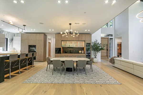 a living room with furniture a chandelier and a rug