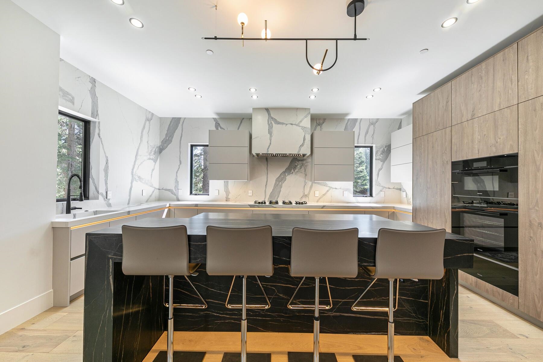 9287 Brae Road Truckee, CA 96161 - Photo 10 of 28 a kitchen with a dining table chairs sink and cabinets