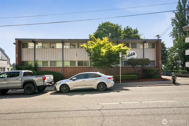 a view of cars parked in front of a house