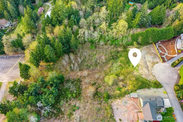 an aerial view of a house with a swimming pool and garden view