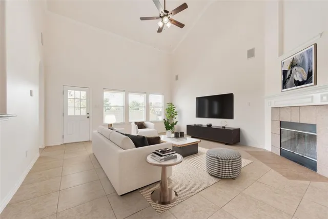 a living room with furniture a flat screen tv and a fireplace