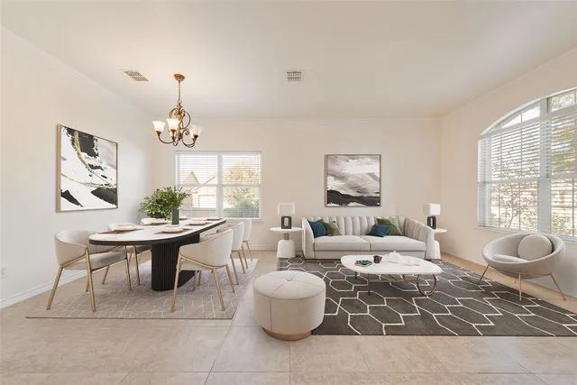 a living room with furniture a chandelier and a window