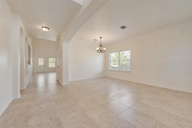 a view of an empty room and a window