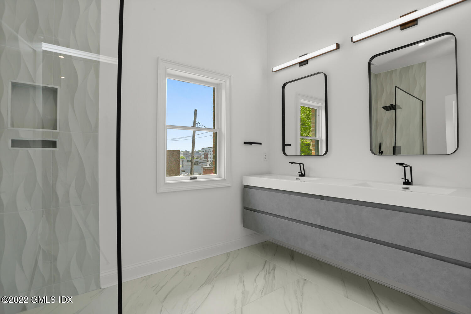 111 Mill Street, Unit PH Greenwich, CT 06830 - Photo 12 of 21 a bathroom with double vanity sink two mirror and window